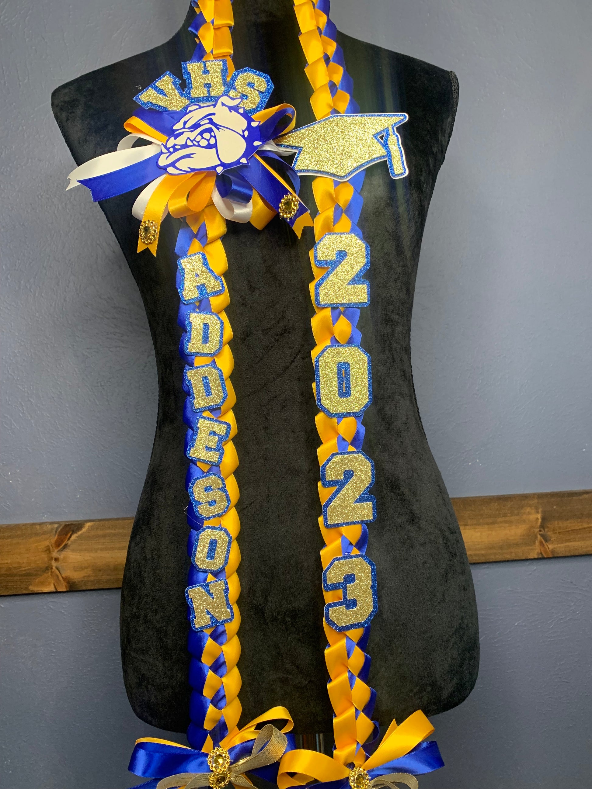 This Graduation Cord is single braided. This Cord comes with grad year, name, bows and grad cap. The mascot (pictured) was an extra charge of $3.